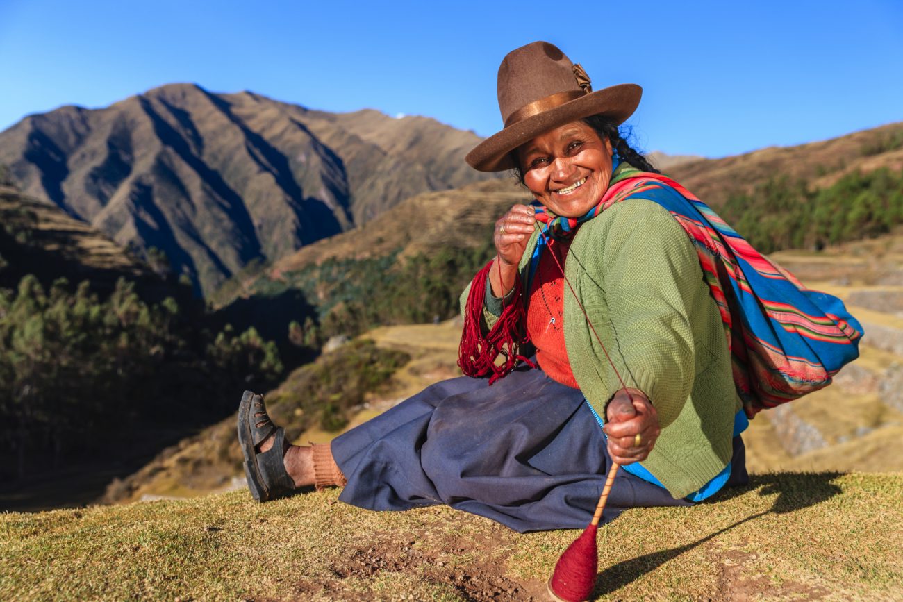 Peruvian woman spinning wool by hand, Sacred Valley, Peru