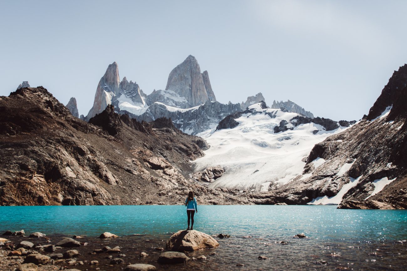Woman looking at Fitz Roy mountain and turquoise lagoon in El Chalten, Argentina